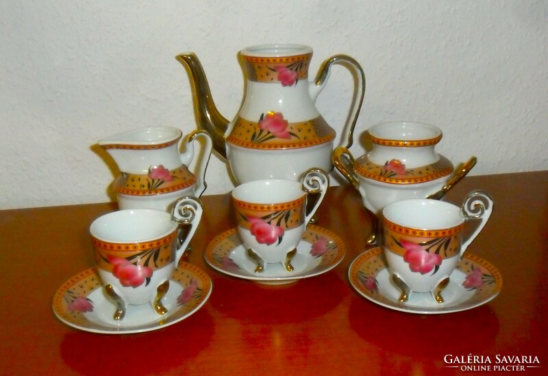 Richly gilded Chinese porcelain standing on graceful legs, 9-piece coffee and tea set.