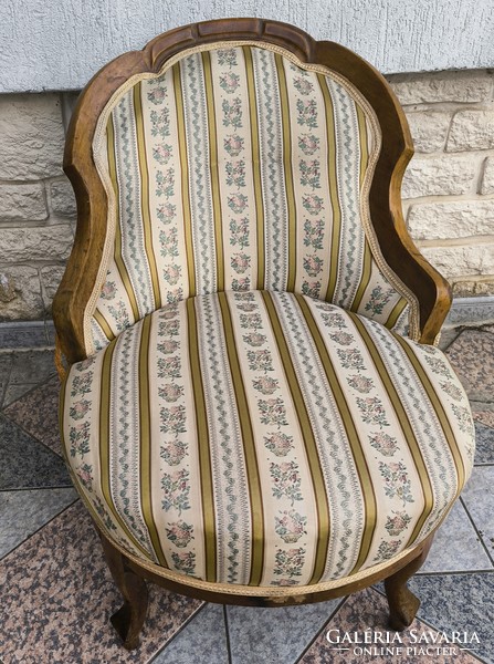 Antique lady's armchair, comfortable armchair for watching TV. Neo-Baroque in a Biedermeier style environment