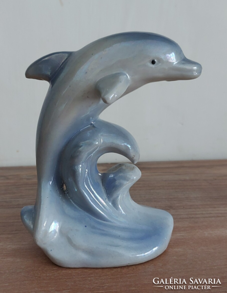 Old unmarked porcelain figurine of a blue dolphin jumping out of the sea, 13 cm high