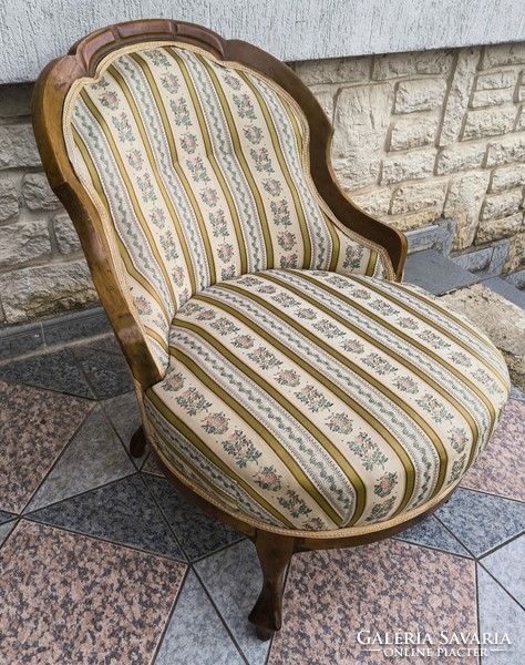 Antique lady's armchair, comfortable armchair for watching TV. Neo-Baroque in a Biedermeier style environment