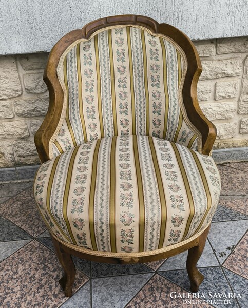Antique lady's armchair, comfortable armchair for watching TV. Neo-Baroque in a Biedermeier style environment