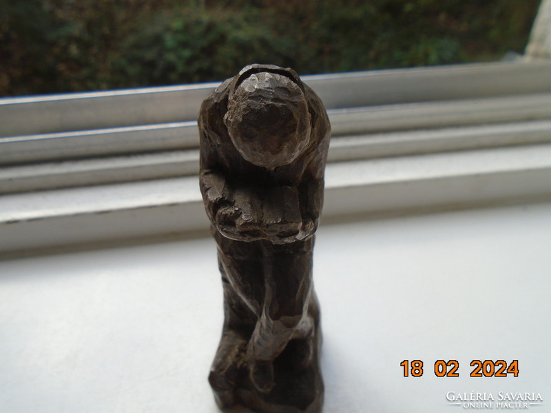 Small sculpture of a man engrossed in reading