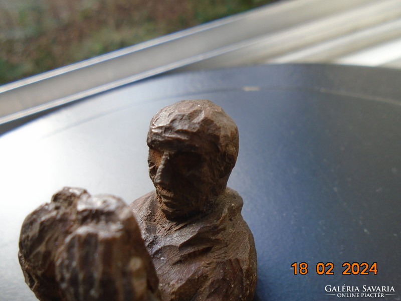 Small sculpture of a man engrossed in reading