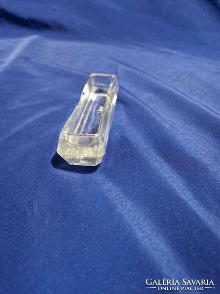 Glass toothpick holder with tooth trough.