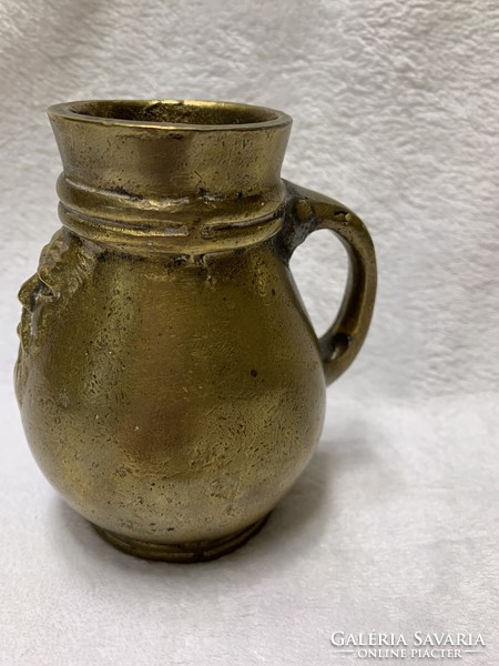 Antique bronze jug with handmade motif