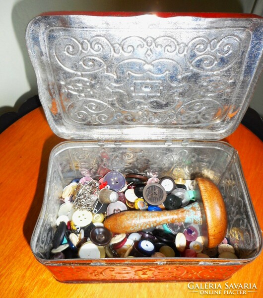Old metal box with sewing supplies (buttons, hitching stick)