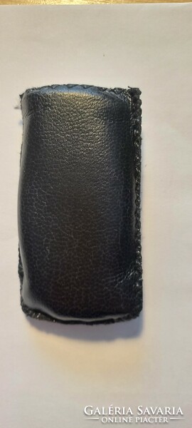 Lighter in an oval shaped leatherette case