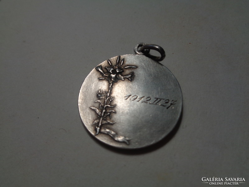 The Holy Family pendant, dated 1912. Made of silver, 25 mm in diameter