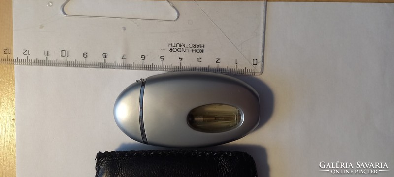 Lighter in an oval shaped leatherette case