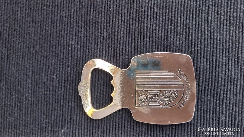 Vintage beer opener, silver, with a bronze embossed dog's head on the front, coat of arms on the back, 8 cm.