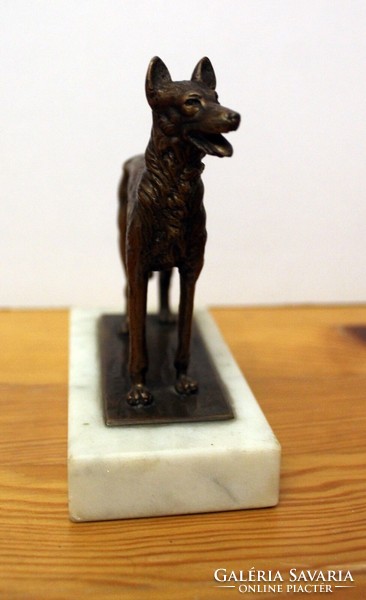 Copper Malinois dog statue on a marble plinth