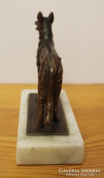 Copper Malinois dog statue on a marble plinth