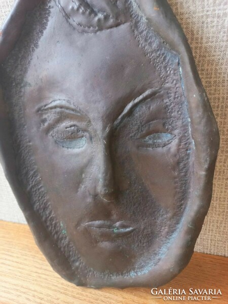 Retro or antique metal wall mask. Goldsmith's work