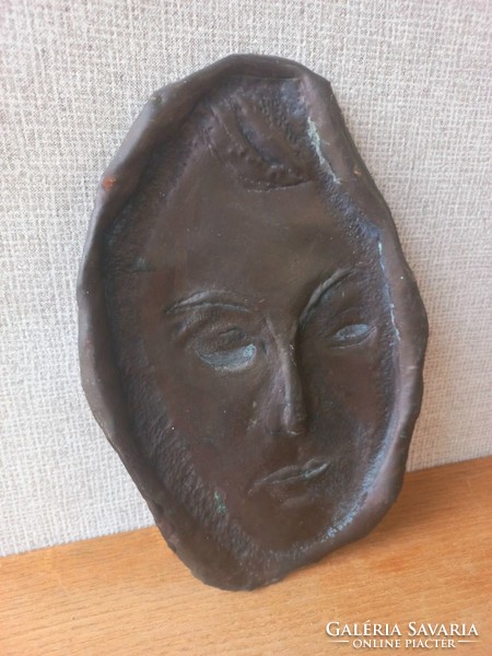 Retro or antique metal wall mask. Goldsmith's work