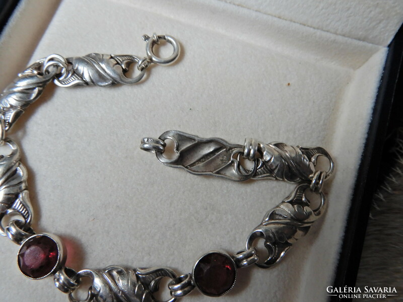 Old silver bracelet with ruby colored stones