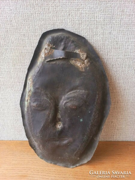 Retro or antique metal wall mask. Goldsmith's work