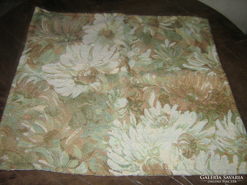 A beautiful woven floral decorative pillow with a spring feel