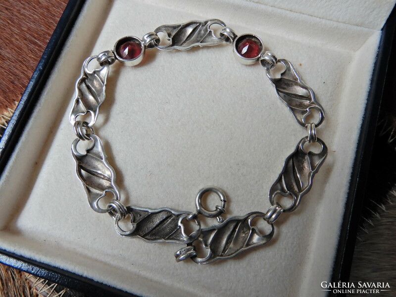 Old silver bracelet with ruby colored stones