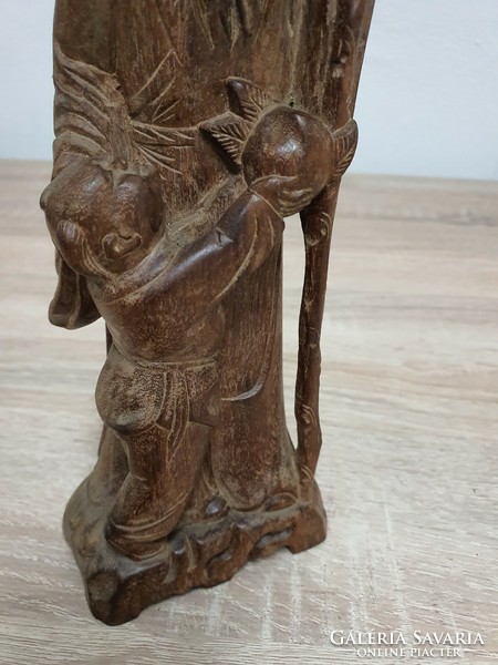 A carved statue depicting an Eastern sage.