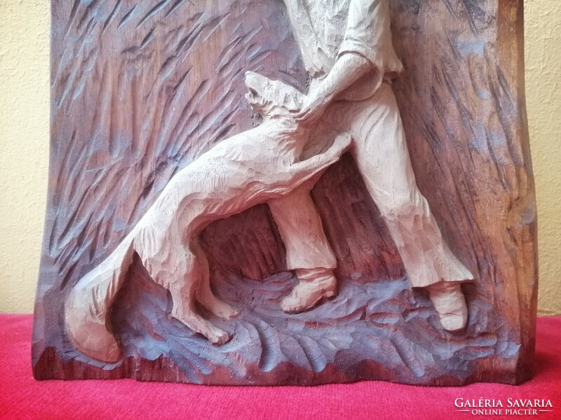 Toldi fighting with wolves. Wood carving