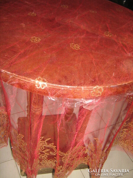 Round tulle tablecloth with a gold pattern in beautiful red material