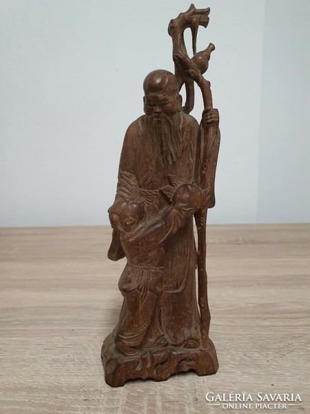 A carved statue depicting an Eastern sage.