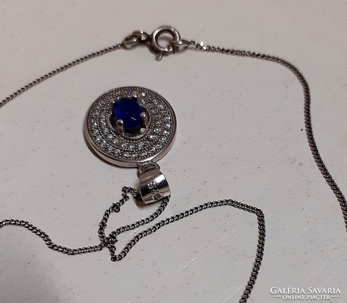 Marked silver necklace with a silver filled sapphire blue circle pendant studded with white zirconia stones