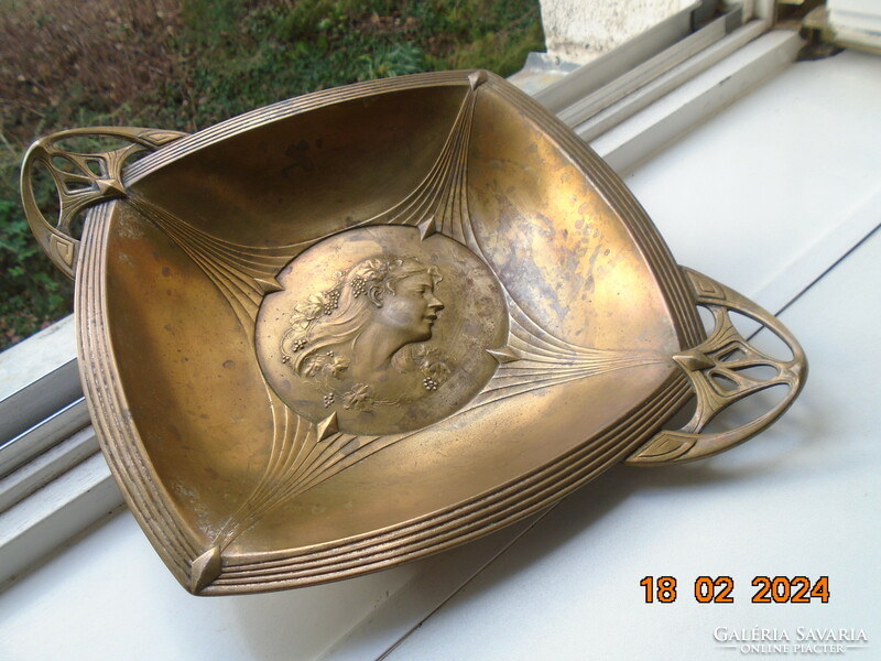 Characteristic art nouveau bowl with repoussé profile of a lady with grape leaves and curls in her hair.