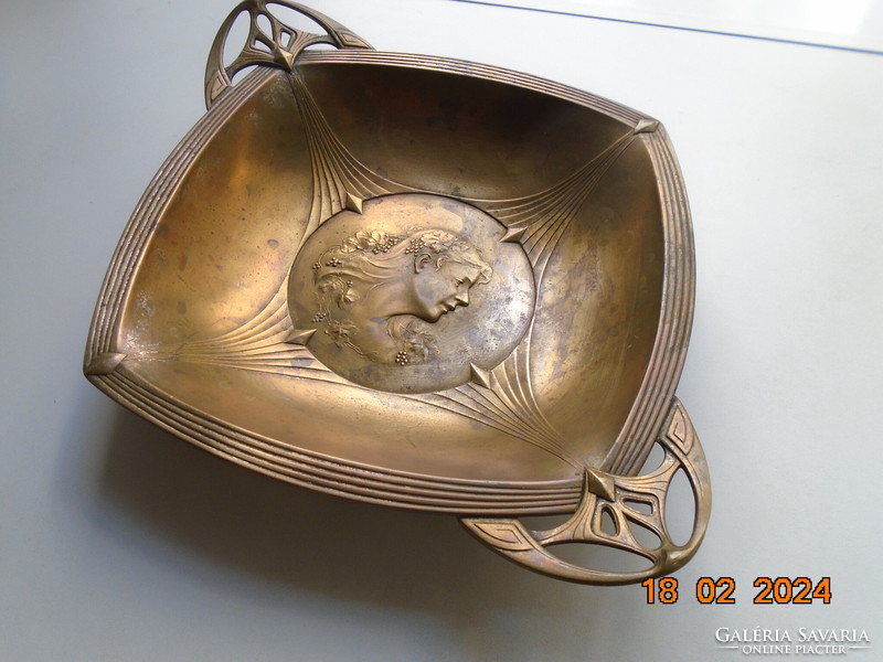 Characteristic art nouveau bowl with repoussé profile of a lady with grape leaves and curls in her hair.