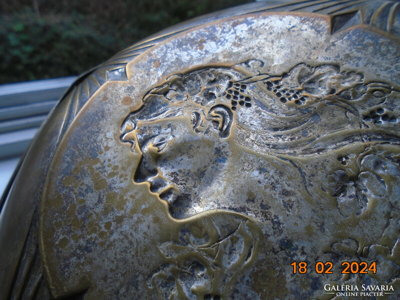 Characteristic art nouveau bowl with repoussé profile of a lady with grape leaves and curls in her hair.
