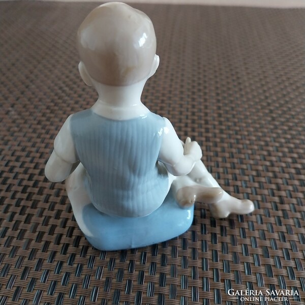 A sitting boy with a dog, hand-painted German porcelain