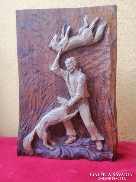 Toldi fighting with wolves. Wood carving