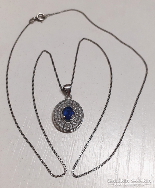 Marked silver necklace with a silver filled sapphire blue circle pendant studded with white zirconia stones