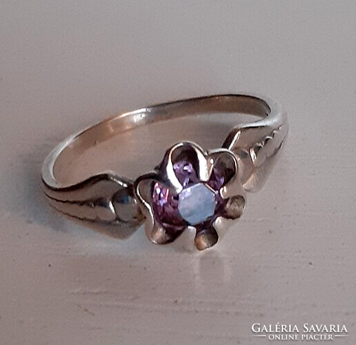 Old hallmarked silver ring in the shape of a flower, encrusted with a polished rose colored zirconia stone