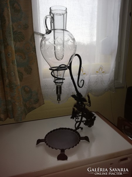 Engraved glass wine dispenser, with ice cube holder, on a wrought iron stand