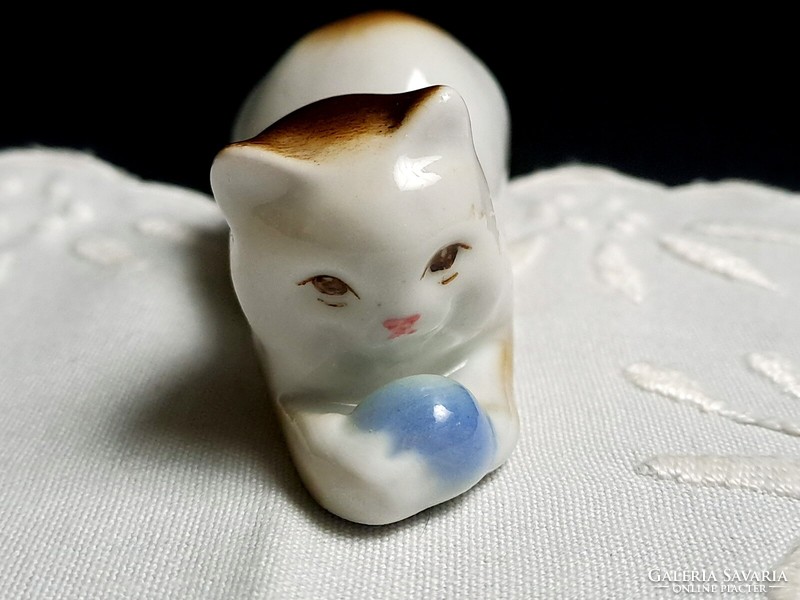 Zsolnay porcelain cat lying down playing with a blue ball 11 cm