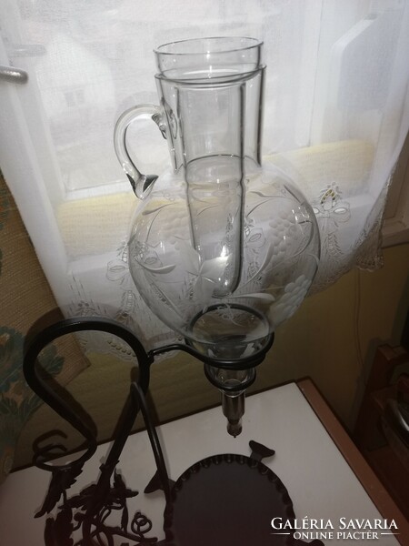 Engraved glass wine dispenser, with ice cube holder, on a wrought iron stand
