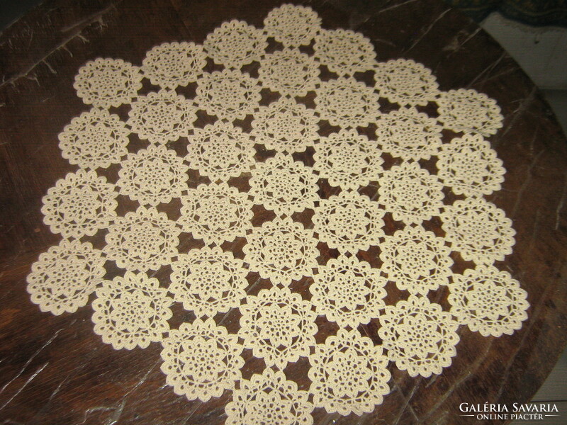Beautiful beige crocheted hexagonal antique lace tablecloth