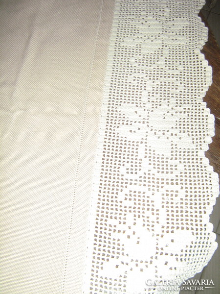 Beautiful hand-crocheted beige tablecloth with pink edges