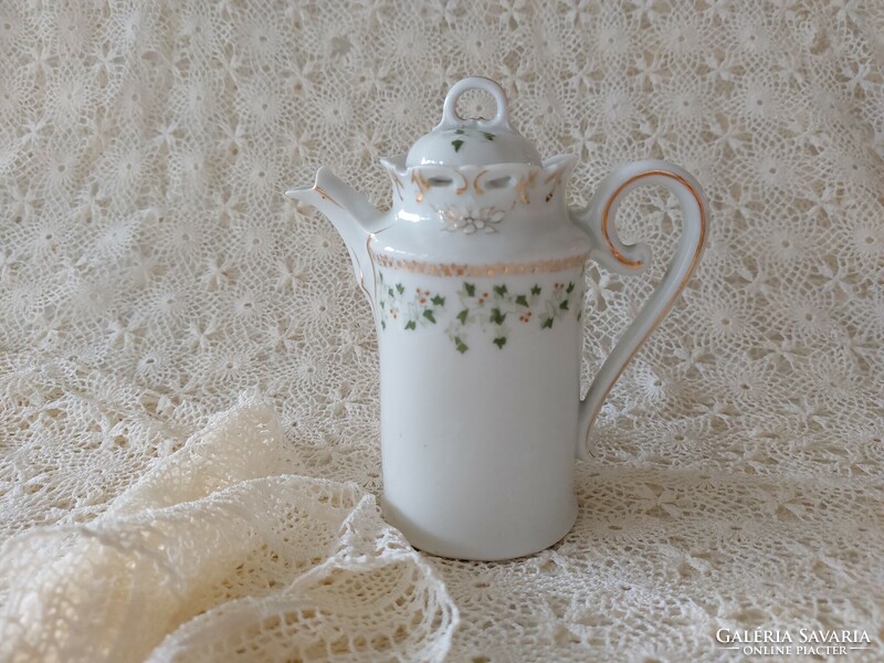 Old porcelain small jug with leaf pattern spout