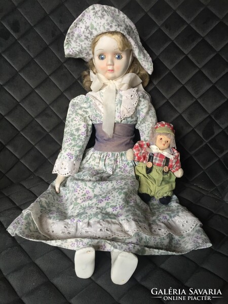 An old, vintage porcelain doll, a porcelain doll, a small doll in one - unfortunately damaged