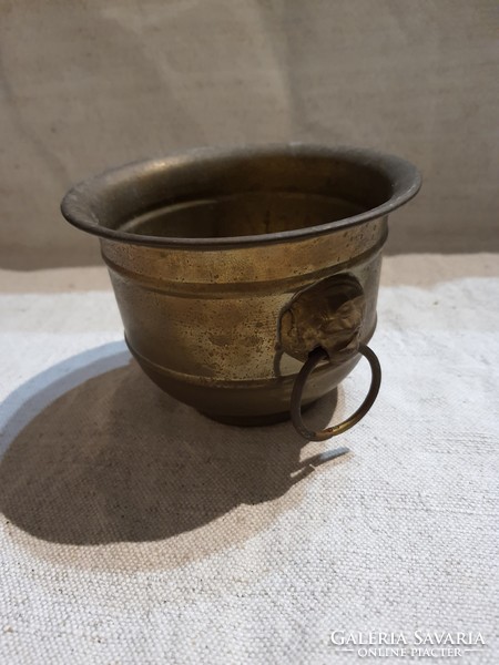 Antique copper pot with lion head handle.