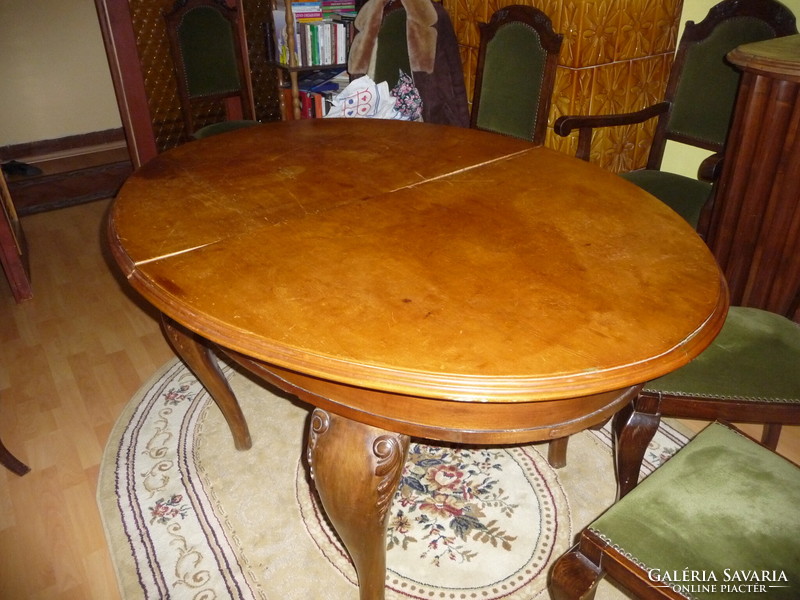 A dining set decorated with neo-baroque style features and a carved structure, from the first half of the 20th century.