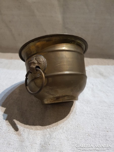 Antique copper pot with lion head handle.