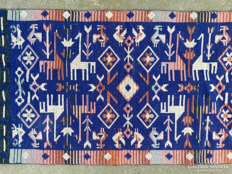 Hand-knotted Bulgarian rug made of blue dyed wool decorated with animals 123 x 66 cm