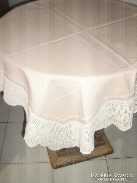 Beautiful hand-crocheted beige tablecloth with pink edges
