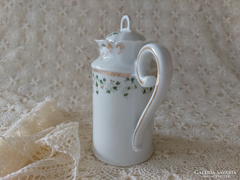 Old porcelain small jug with leaf pattern spout