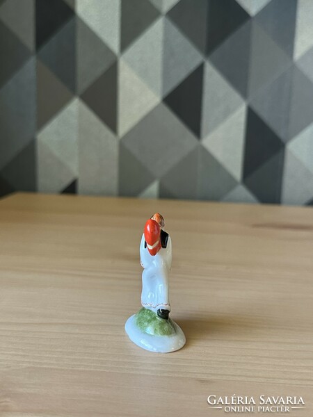 Antique mini figure from Old Herend, a lad carrying a heart on his shoulder.