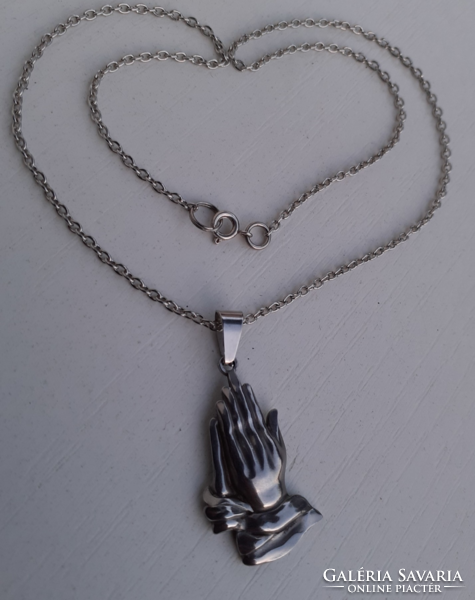 Silver-plated necklace with a pendant depicting a praying hand