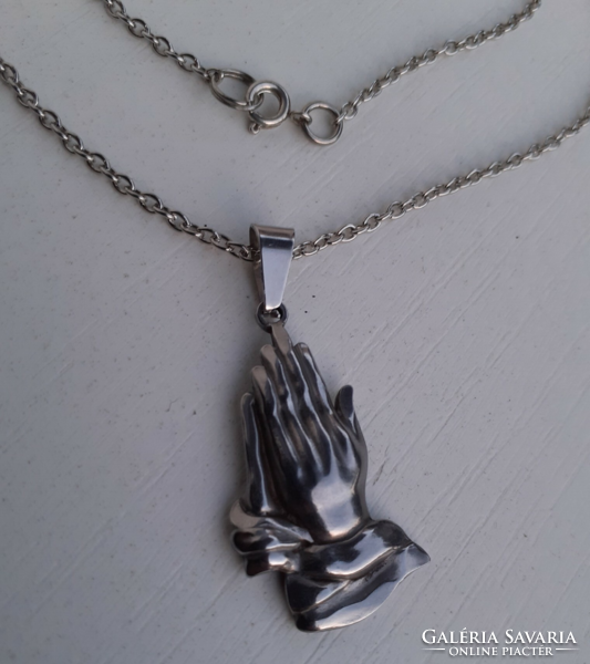 Silver-plated necklace with a pendant depicting a praying hand